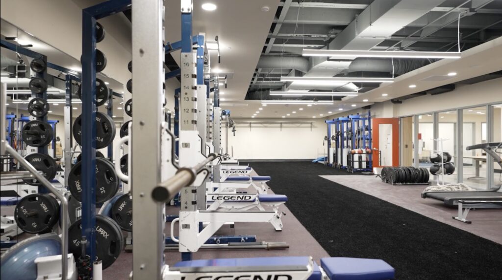 Weight room at the International School of San Francisco with squat racks, benches and free weights